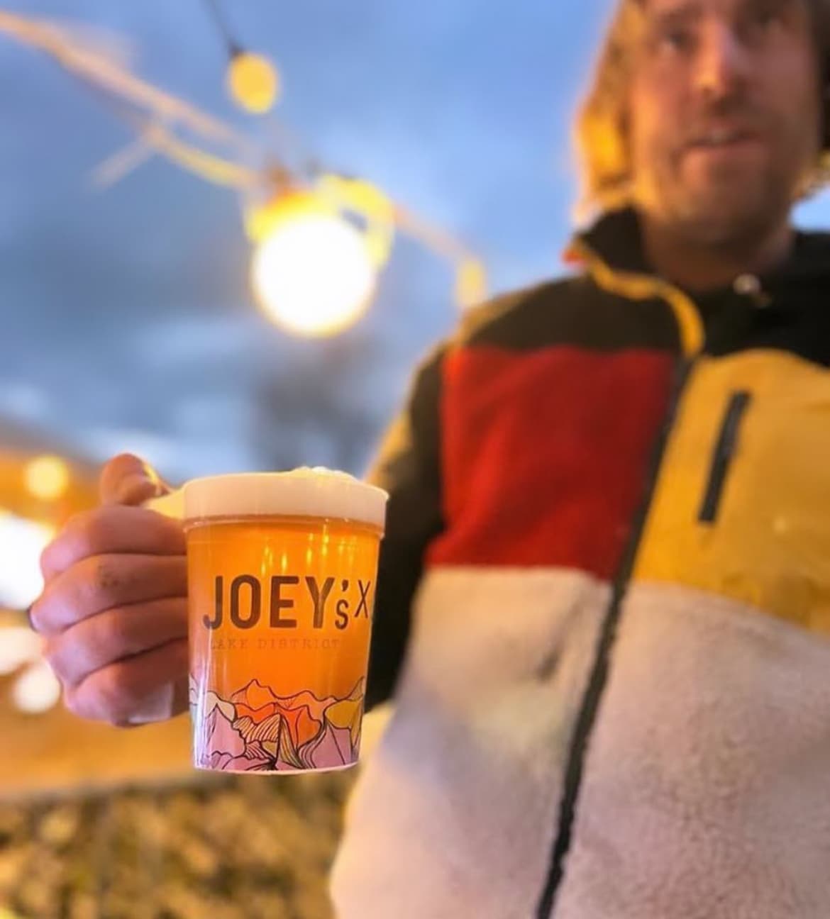 Reusable plastic festival pint cups stacked and branded for an event